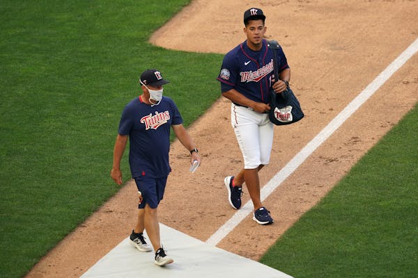 Twins pitcher José Berríos walked with pitching coach Wes Johnson as he took the field during practice last Friday.