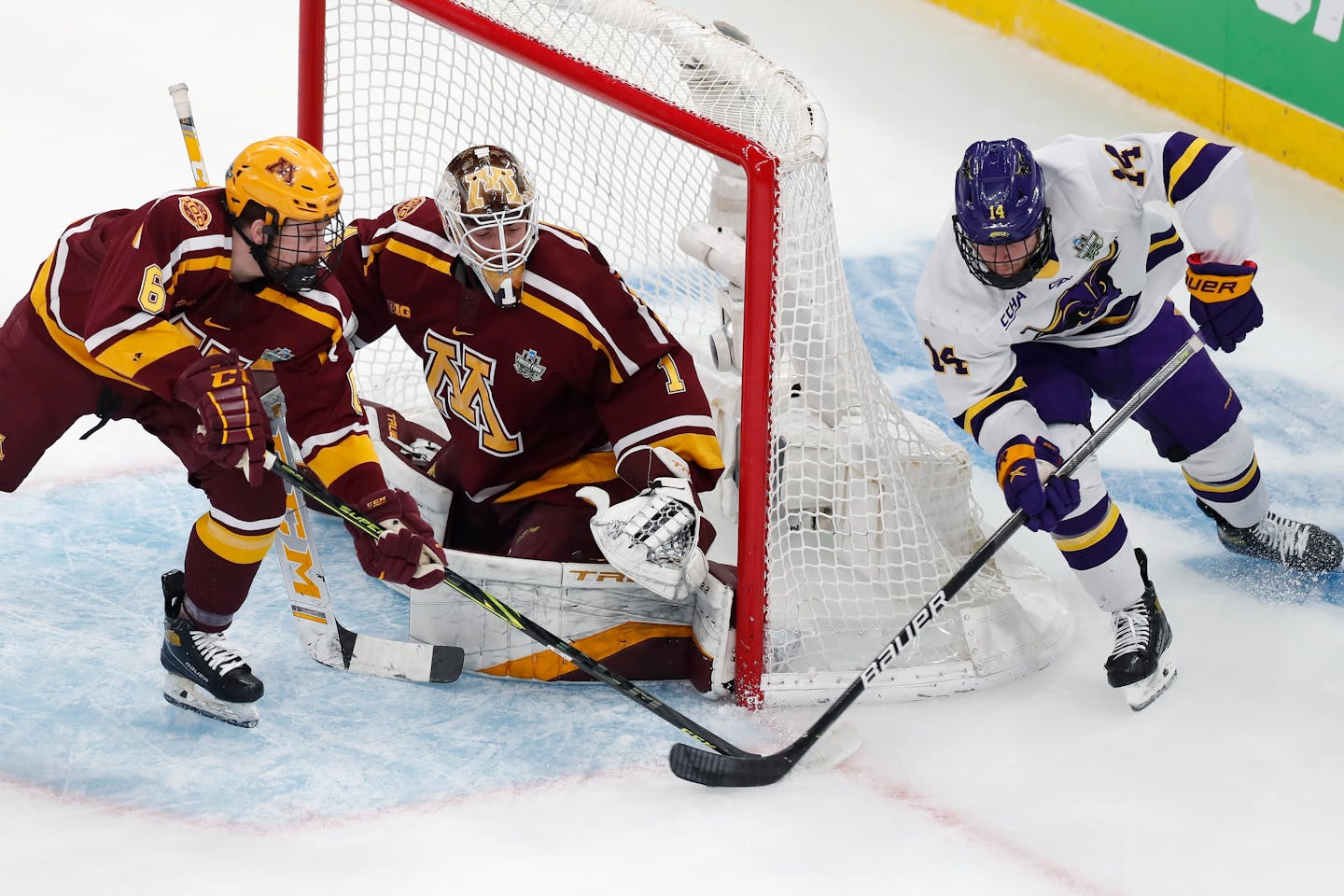 Minnesota State's Ryan Sandelin (14) tries to get the puck past Minnesota's Justen Close (1) as Mike Koster (6) defends during the first period of an NCAA men's Frozen Four men's hockey semifinal Thursday, April 7, 2022, in Boston. (AP Photo/Michael Dwyer)