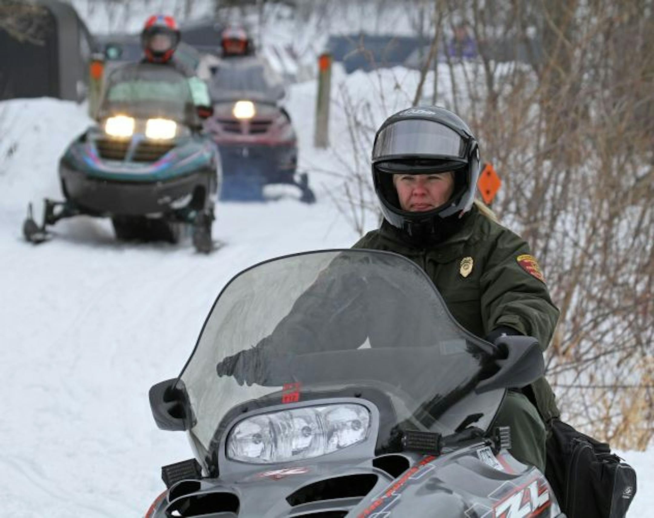 DNR conservation officer Jackie Glaser patrolled the Luce Line Trail near Lake Minnetonka. Near-record snowfalls have boosted snowmobile activity in the Twin Cities region.