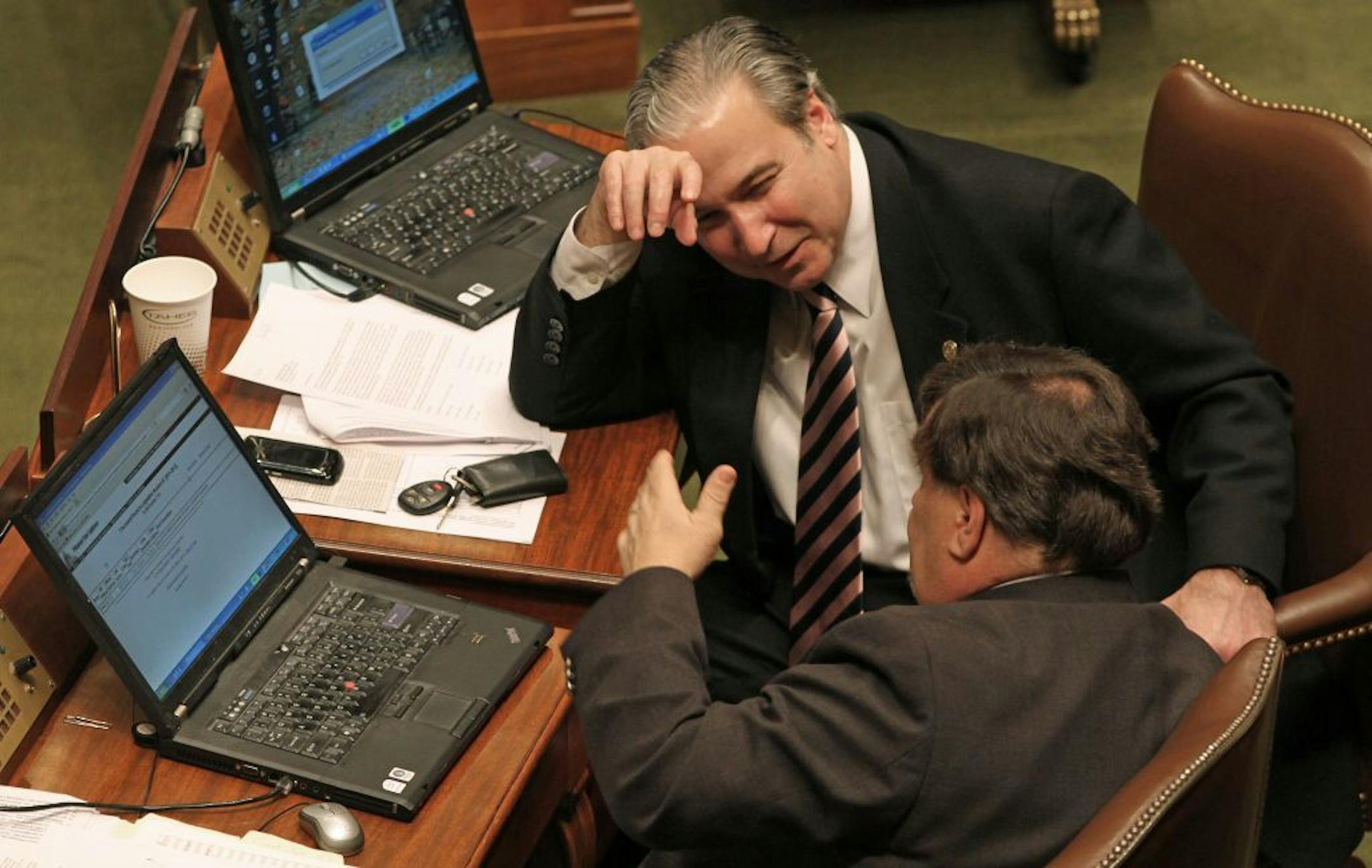 DFL state Reps. John Ward of Brainerd, front, and Michael Paymar of St. Paul talked as the House was meeting on Saturday.