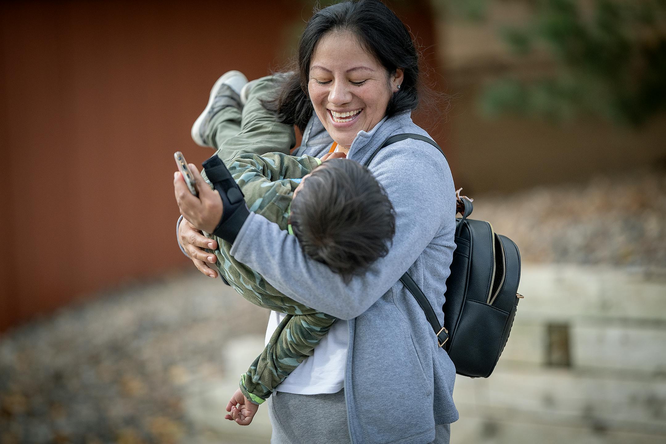 Maria plays with her son outside a homeless family shelter in Bloomington, Minn., on Oct. 18. Maria heard about Minnesota from a woman she met in the dangerous jungle known as the Darien Gap.