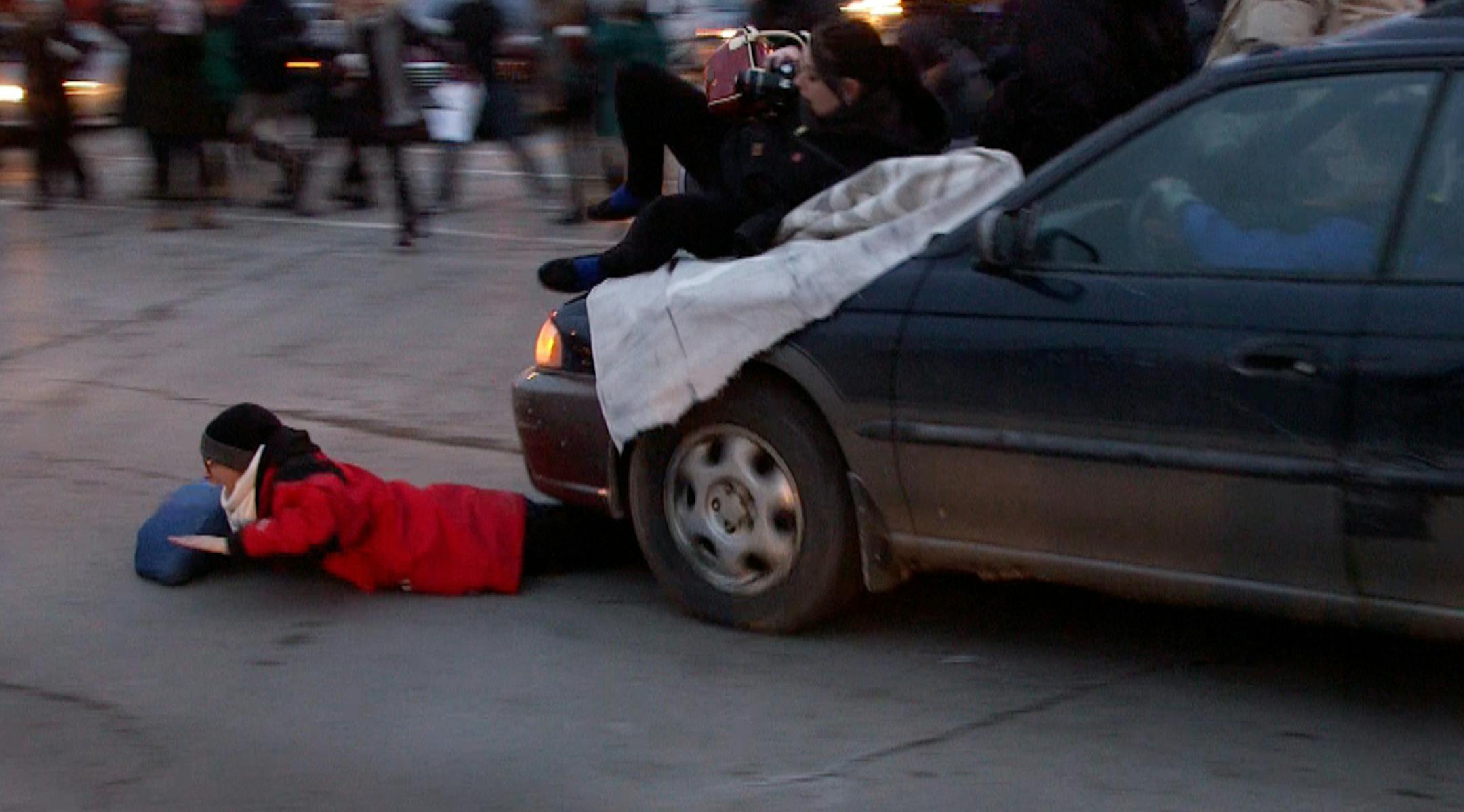 A car plowed through a Ferguson rally in South Minneapolis after protesters blocked the intersection of Lake Street and Minnehaha Ave on Tuesday, Nov. 25, 2014 . One woman was taken away by an ambulance. ORG XMIT: MIN1411251742141445 ORG XMIT: MIN1411251759481455