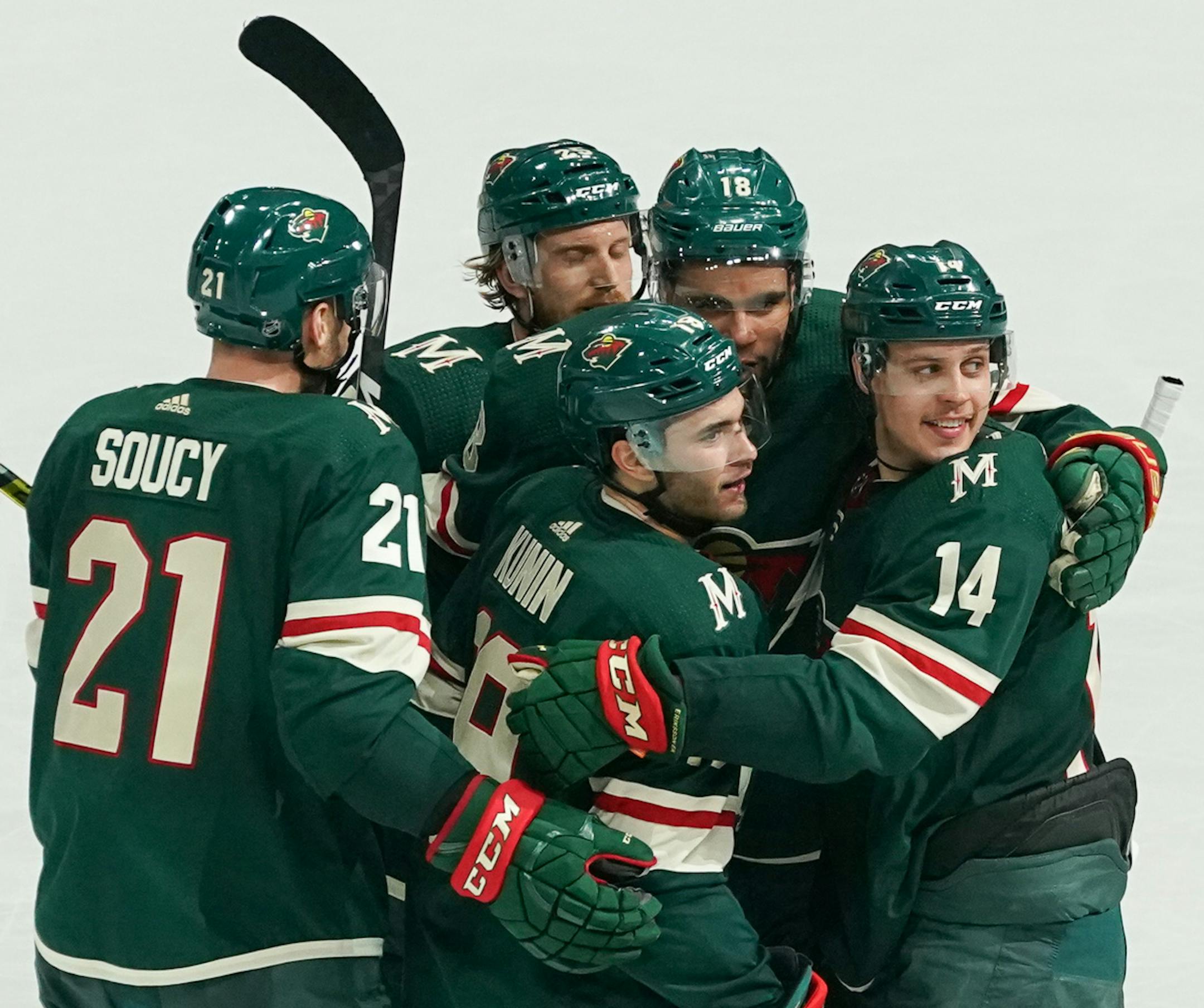 Luke Kunin (19) is in the center of congratulations for Minnesota's sixth and final goal of the game beating Edmonton 6-5.