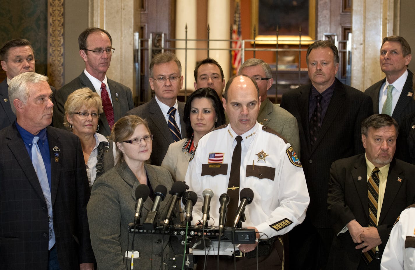 A bipartisan group of lawmakers and members of the Minnesota Sheriff's Association stood in front of the House chambers to introduce an alternative gun bill that doesn't include background checks. The bill's author is Rep. Debra Hilstrom, center and is supported by Sen Tony Cornish, left, a gun rights advocate and Hennepin County Sheriff Rich Stanek, center. ] GLEN STUBBE * gstubbe@startribune.com