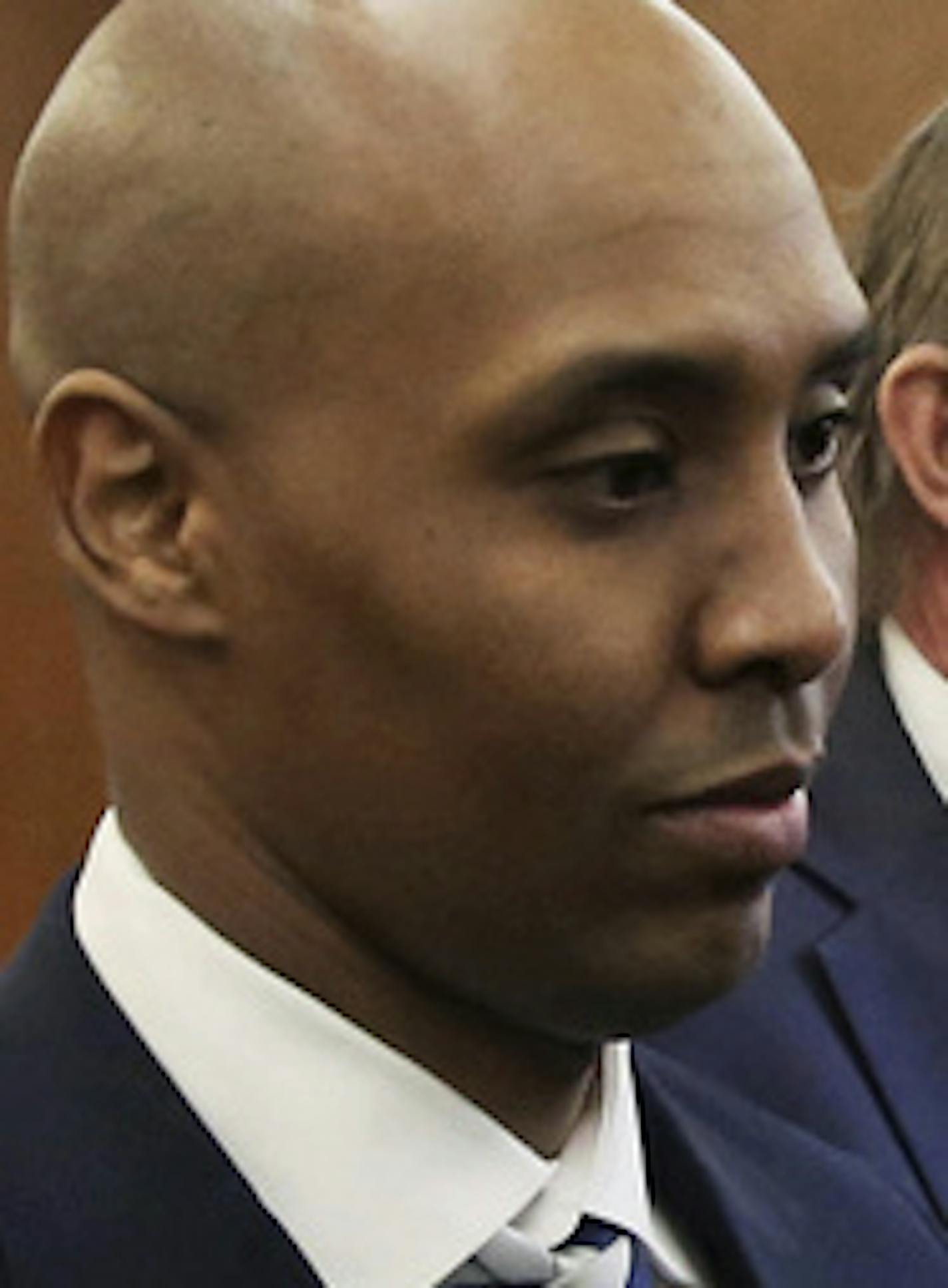 Mohamed Noor, left, former Minneapolis police officer, leaves the Hennepin County Government Center in Minneapolis Friday, March 1, 2019 with attorney Peter Wold after a hearing to address several pretrial motions.at Noor is charged with second-degree intentional murder, third-degree murder and second-degree manslaughter in the July 15, 2017, shooting death of Justine Ruszczyk Damond, a 40-year-old life coach and Australian-American who had called 911 to report a possible sexual assault behind h