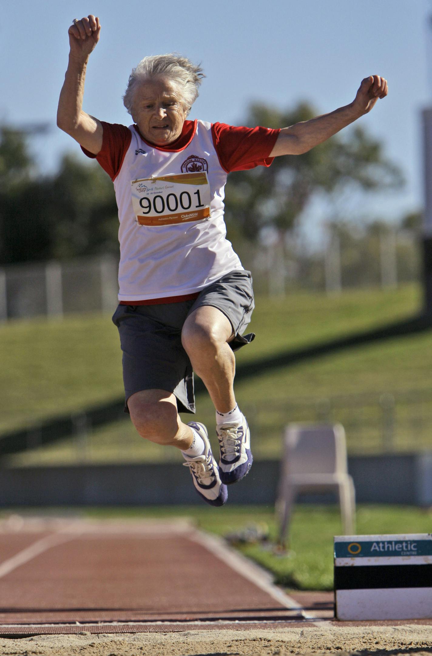 Canada's Olga Kotelko, 90, makes a leap while competing in the women's long jump during the Masters Games in Sydney Friday, Oct. 16, 2009. (AP Photo/Rick Rycroft) ORG XMIT: XRR102