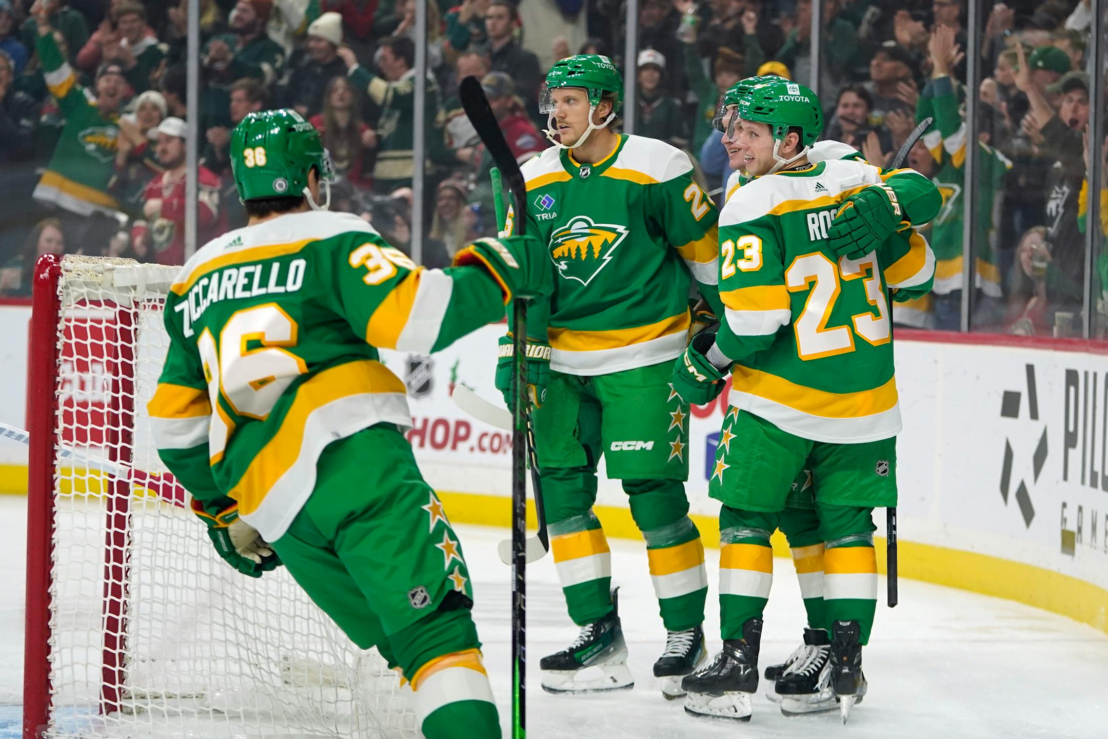 Minnesota Wild center Marco Rossi celebrates with teammates after scoring during the first period of an NHL hockey game against the Chicago Blackhawks, Sunday, Dec. 3, 2023, in St. Paul, Minn. (AP Photo/Abbie Parr)