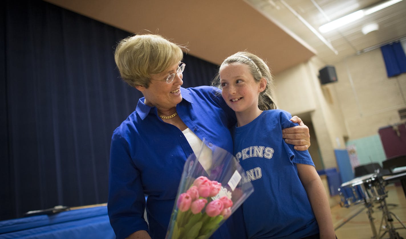 Kay Hawley embraces Meghan O'Reilly and gives her words of encouragement after Tuesday night's concert. ] (Aaron Lavinsky | StarTribune) aaron.lavinsky@startribune.com Kay Hawley, a Hopkins music teacher, is retiring after 42 years. Recently, the district invited back some of her former students for a concert to give her a Mr. Holland's Opus type send off. The concert was held Tuesday, May 5, 2015 at Glen Lake Elementary in Minnetonka.