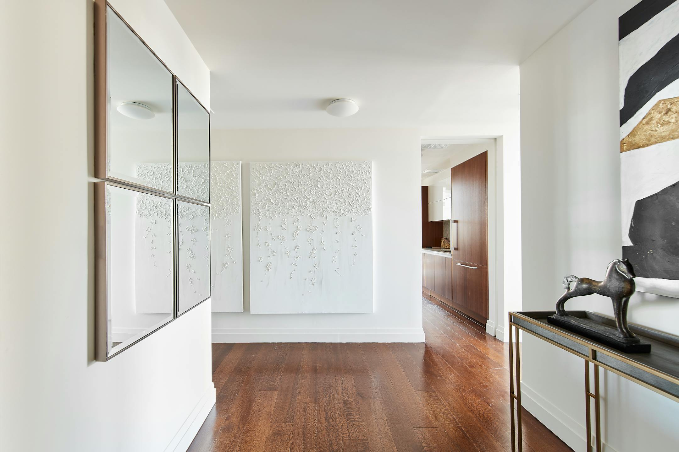 A blend of artwork and mirrors helps to add interest to this multi-entrance hallway. (Scott Gabriel Morris/TNS)