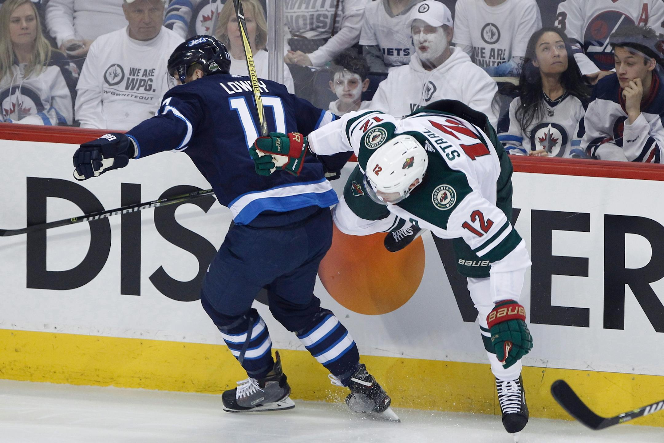 Winnipeg Jets' (12) and Minnesota Wild's Eric Staal (12) collide during the first period of Game 1 in an NHL hockey first-round playoff series Wednesday, April 11, 2018, in Winnipeg, Manitoba.