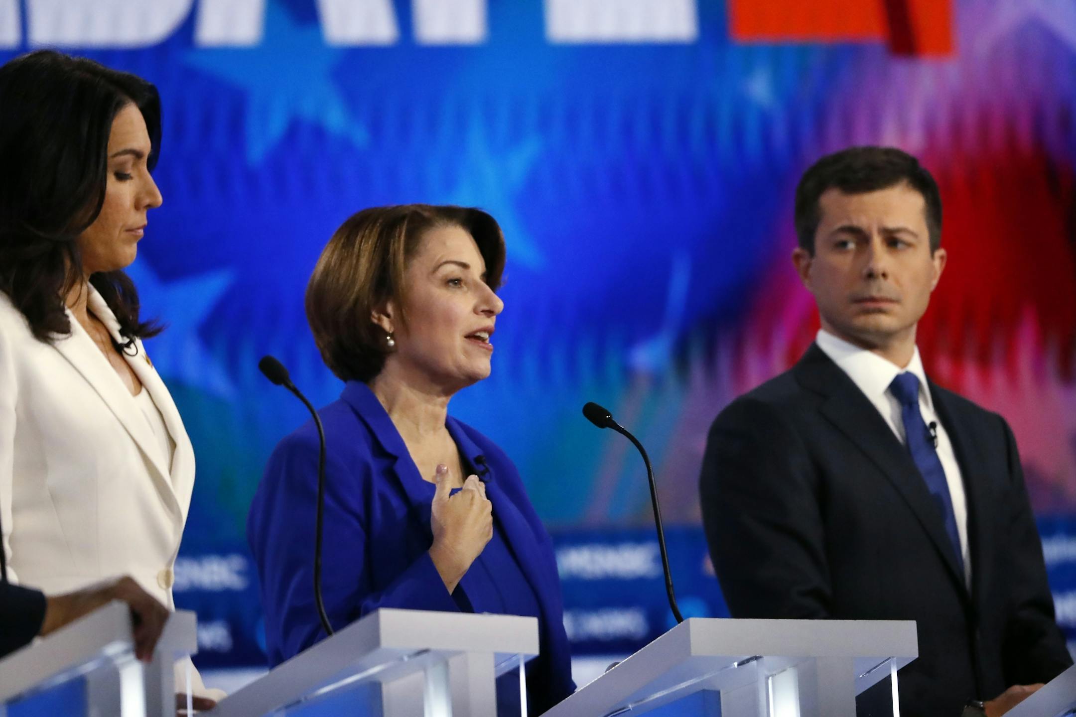 Sen. Amy Klobuchar, D-Minn., center speaks as Rep. Tulsi Gabbard, D-Hawaii, left, and South Bend, Ind., Mayor Pete Buttigieg listen during a Democratic presidential primary debate, Wednesday, Nov. 20, 2019, in Atlanta.