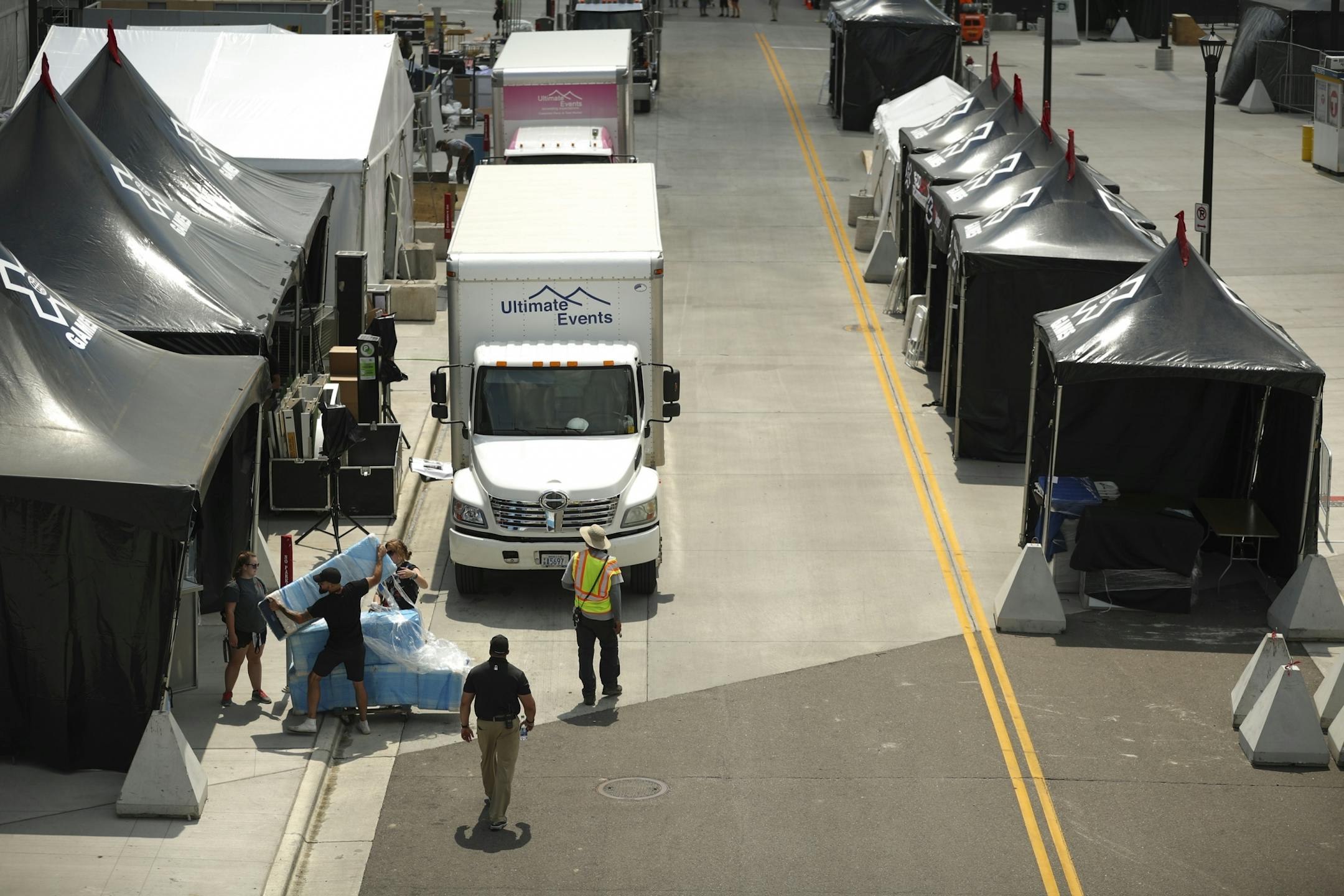 Workers set up tents on Chicago Ave. S. in front of U.S. Bank Stadium.