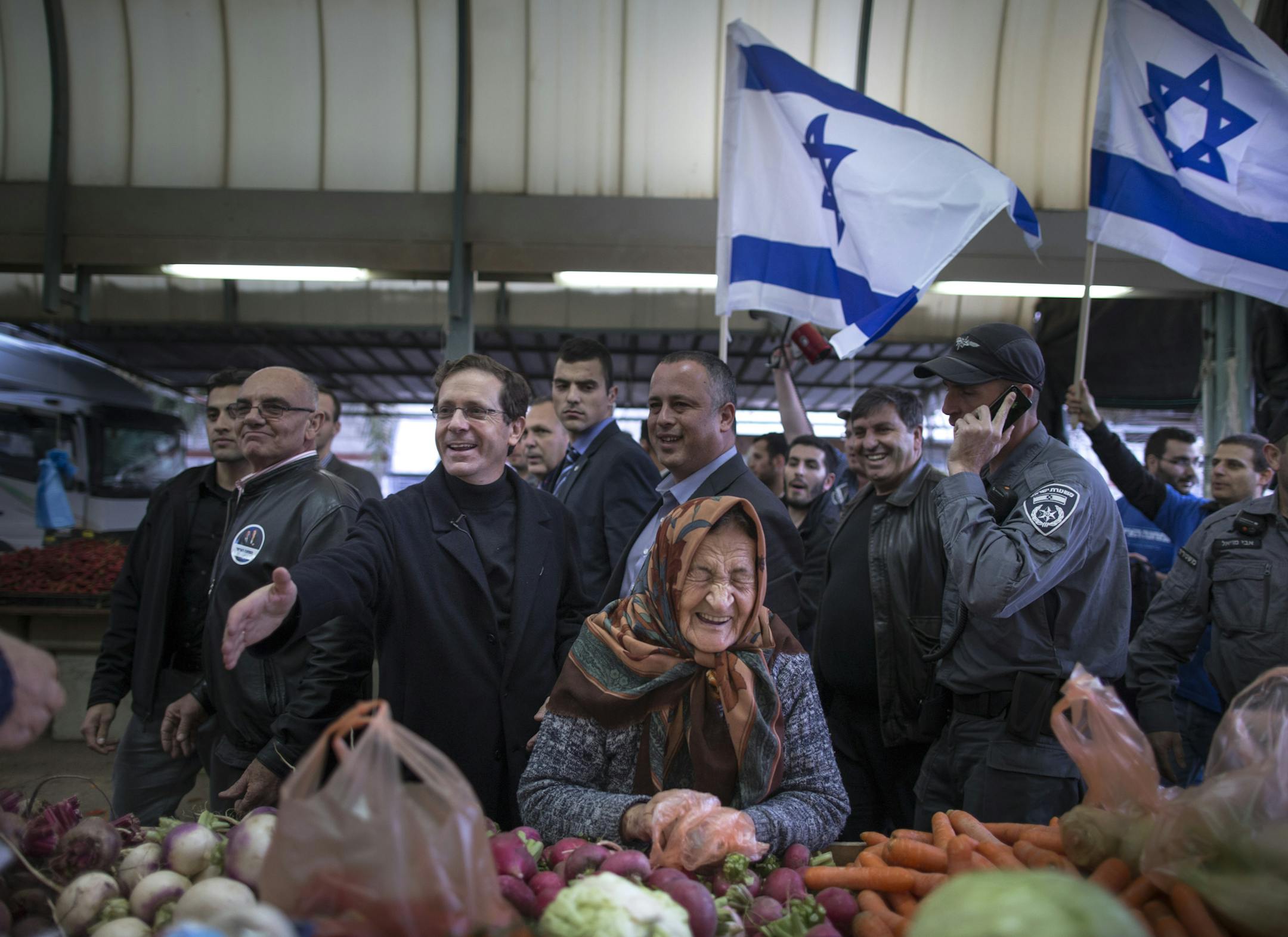 Isaac Herzog, a co-founder of the Zionist Union, outstretches his hand to greet others during a campaign stop at a local market while touring Beit She'an, Israel, Feb. 18, 2015. Herzog has surprised supporters and detractors by maneuvering himself into position as a realistic contender for the post of prime minister. (Uriel Sinai/The New York Times)