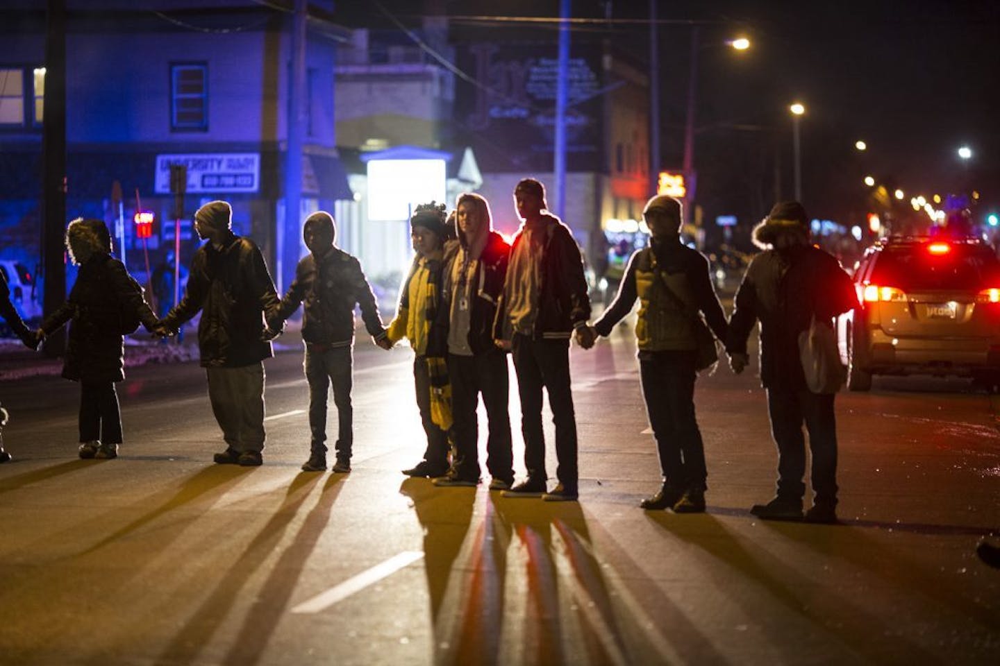 Protesters made a large circle holding hands before ending their march at the Minneapolis Police Federation headquarters on Thursday night in Minneapolis.