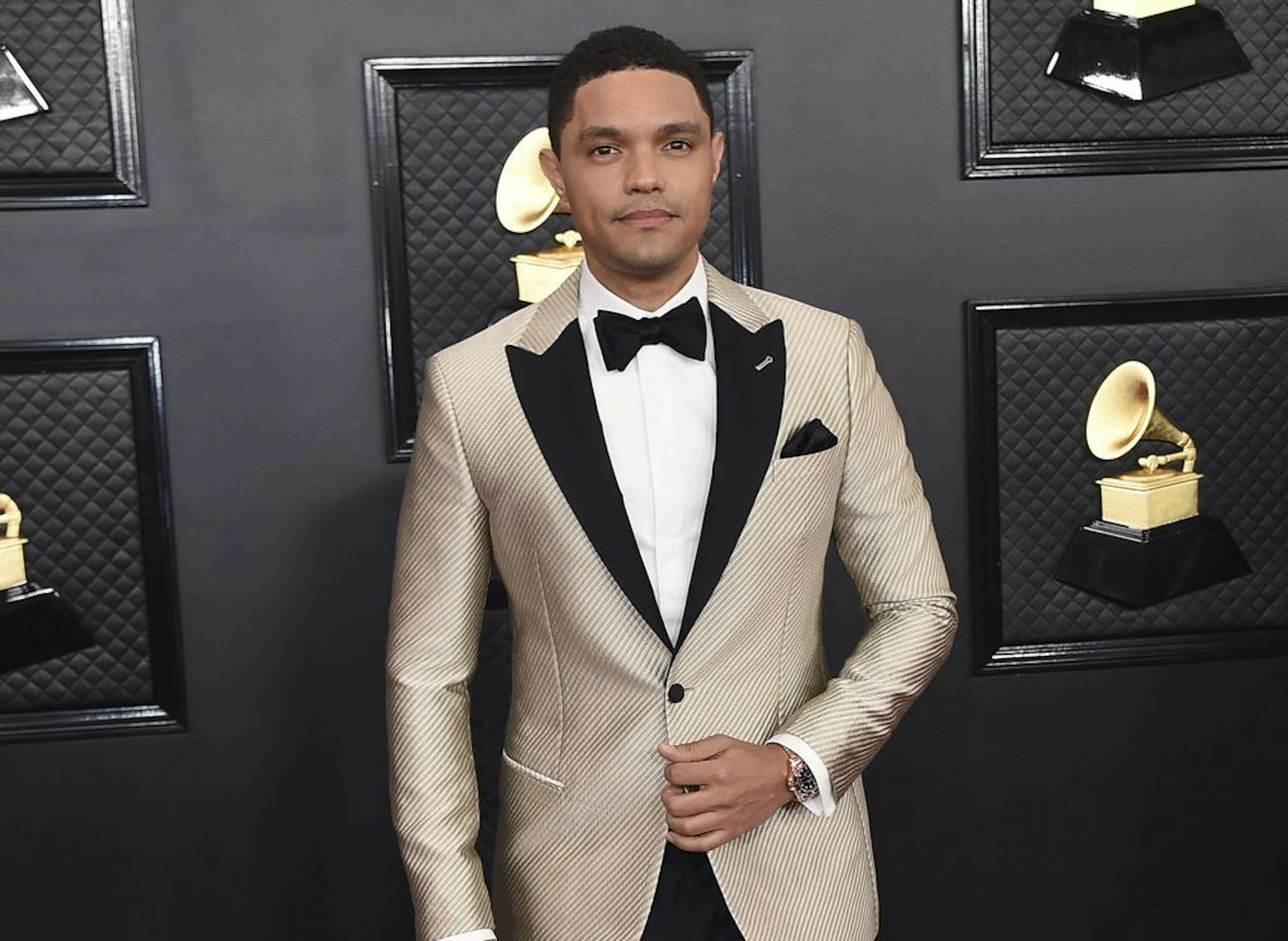 FILE - Trevor Noah arrives at the 62nd annual Grammy Awards in Los Angeles on Jan. 26, 2020. Noah has been tapped to host the 2021 Grammy Awards. The Recording Academy made the announcement hours before the nominees for the 2021 show would be revealed. It would mark Noah's first time hosting the Grammys.