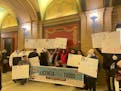 Driver’s Licenses for All campaign supporters gather after a House Transportation Committee meeting at the Minnesota State Capitol on Tuesday, Jan. 