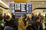 Passengers wait at Heathrow Airport in London, Friday, Dec. 12, 2014. London's airspace was closed today due to what authorities say was a computer failure at one of Britain's two air traffic control centres. Britain's national air traffic body says the computer problem that touched off troubles in the system has been fixed and it is in the process of returning to normal operations. (AP Photo/Vadim Ghirda)