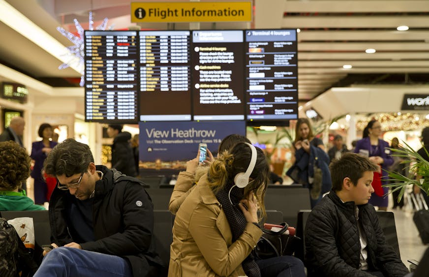 Passengers wait at Heathrow Airport in London, Friday, Dec. 12, 2014. London's airspace was closed today due to what authorities say was a computer failure at one of Britain's two air traffic control centres. Britain's national air traffic body says the computer problem that touched off troubles in the system has been fixed and it is in the process of returning to normal operations. (AP Photo/Vadim Ghirda)