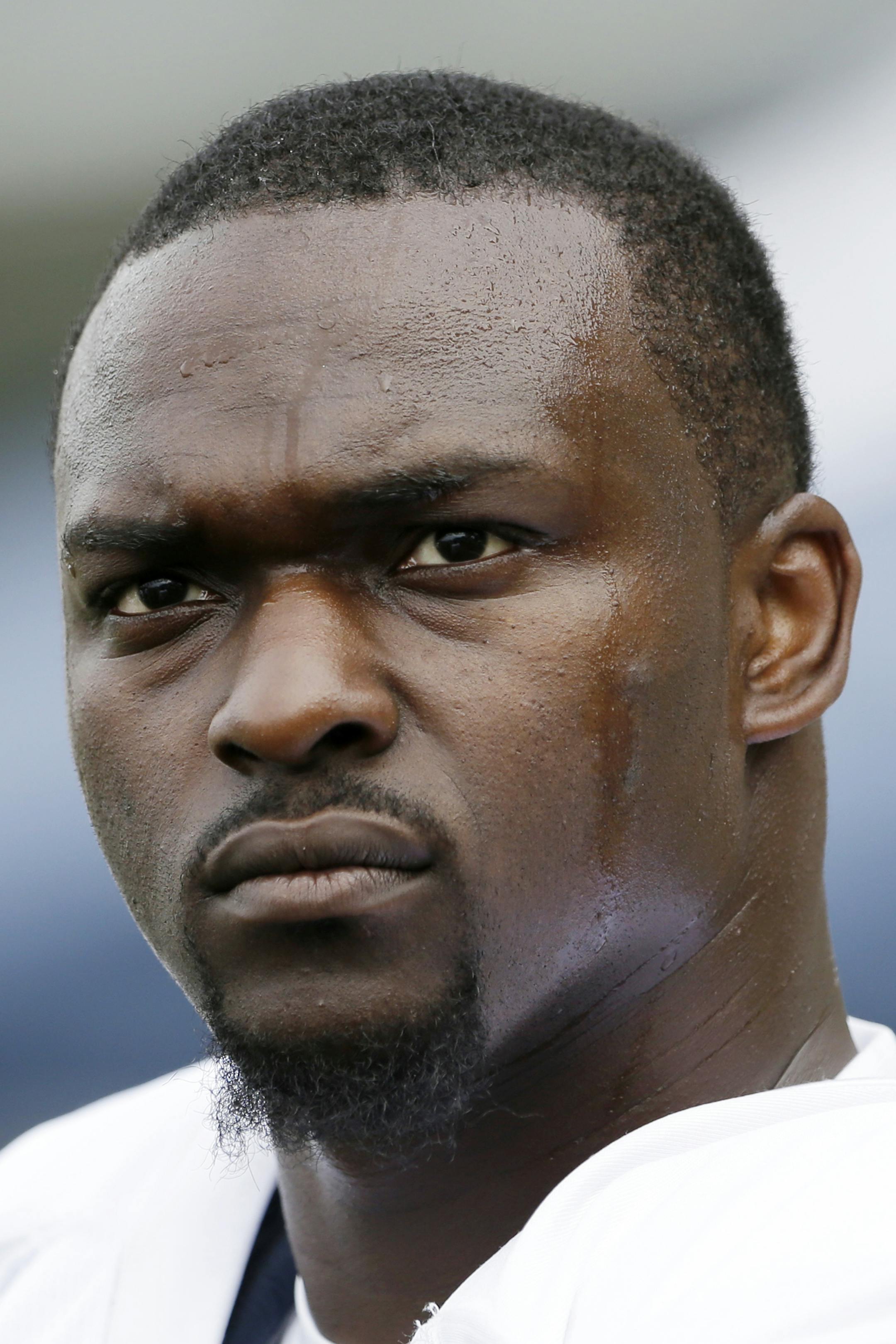 Seattle Seahawks' Cliff Avril waits for a drill to begin at an NFL football training camp Wednesday, Aug. 14, 2013, in Renton, Wash. (AP Photo/Elaine Thompson) ORG XMIT: MIN2013090519392645