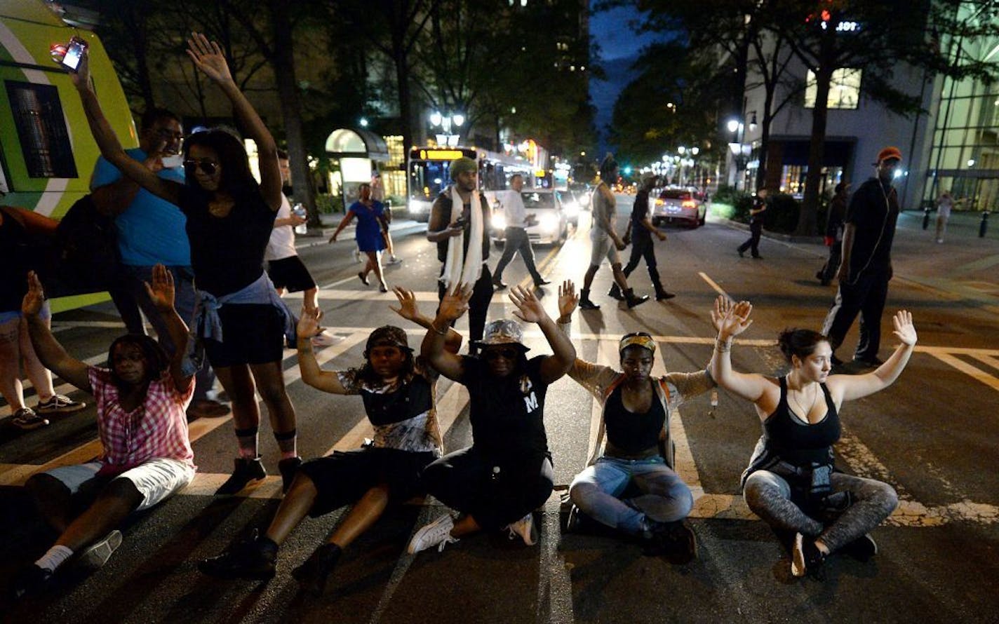 Protestors block an intersection at Trade and Tryon Streets in Charlotte, N.C., on Wednesday, Sept. 21, 2016. The protestors were rallying against the fatal shooting of Keith Lamont Scott by police on Tuesday evening in the University City area.