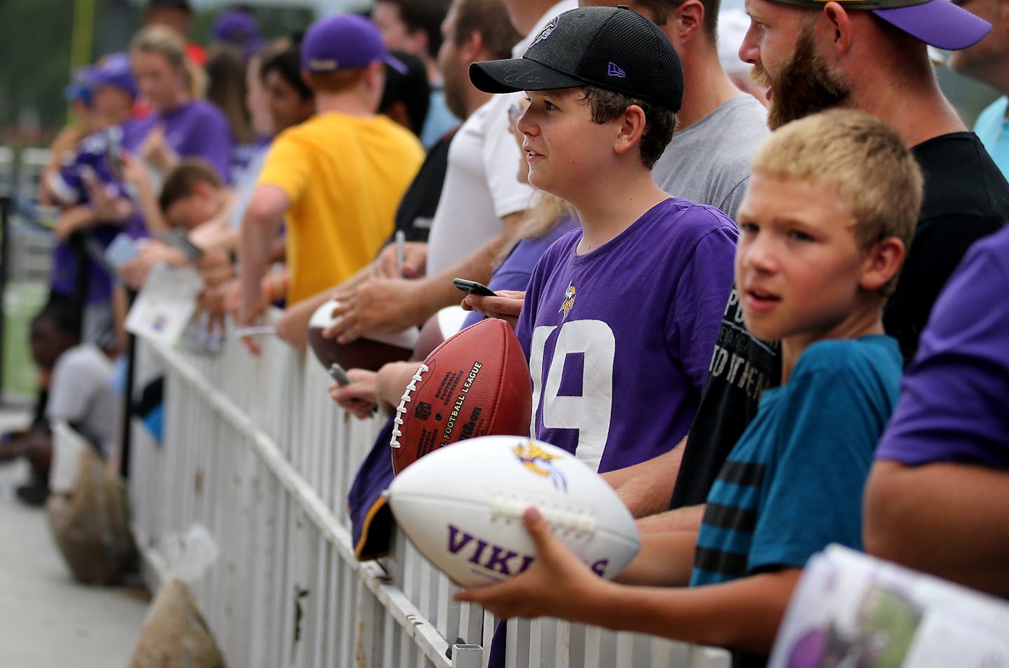 Youngsters waited hopefully to get autographs from players.