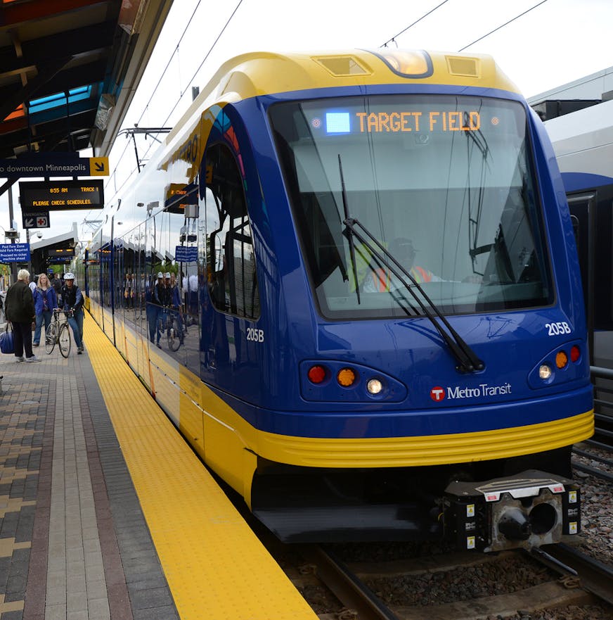 The Hiawatha Light Rail Line is being rebranded as the METRO Blue Line. The Blue Line is the first of the Twin Cities METRO system of rapid transit lines which include METRO Red Line Bus Rapid Transit on Cedar Ave. METRO Blue Line trains will now have three cars and will run every ten minutes throughout most of the day. Twelve new light-rail vehicles dedicated to the line will allow this increased service capacity. During the kickoff event Metro Transit staff handed out Blue line pens, new sched