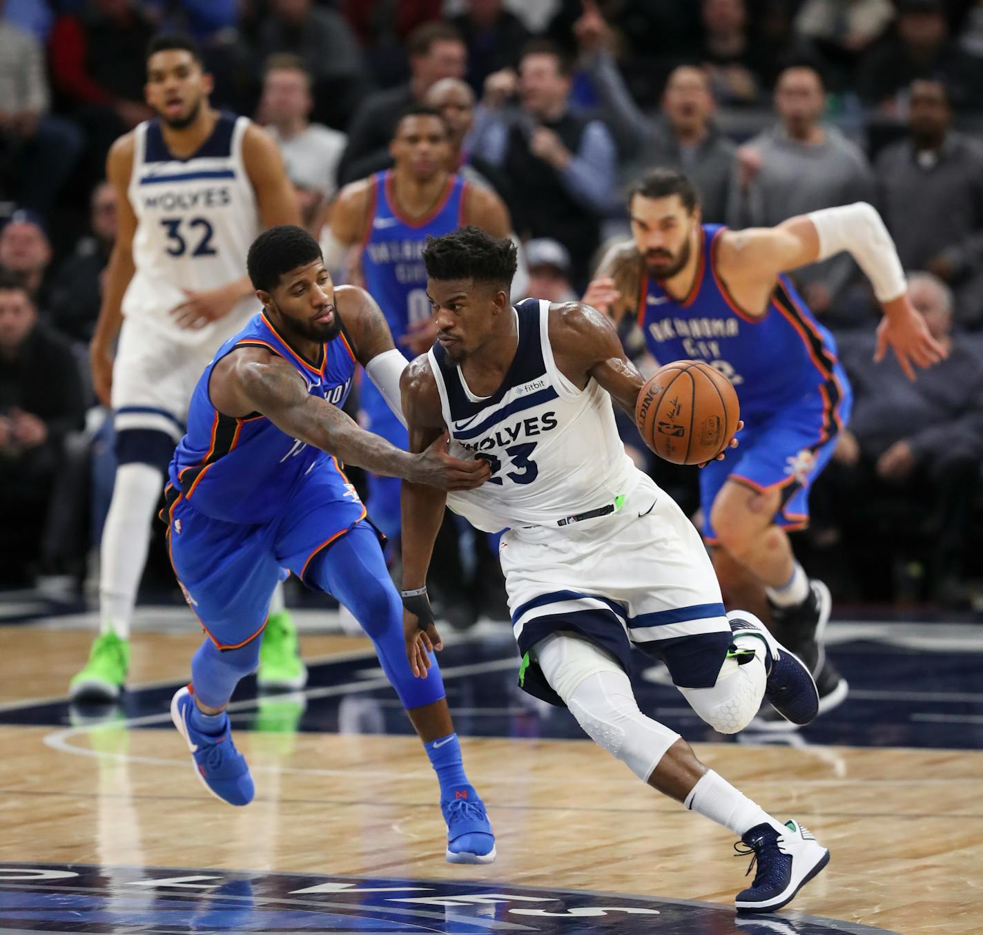 Oklahoma City's Paul George fouls the Timberwolves' Jimmy Butler