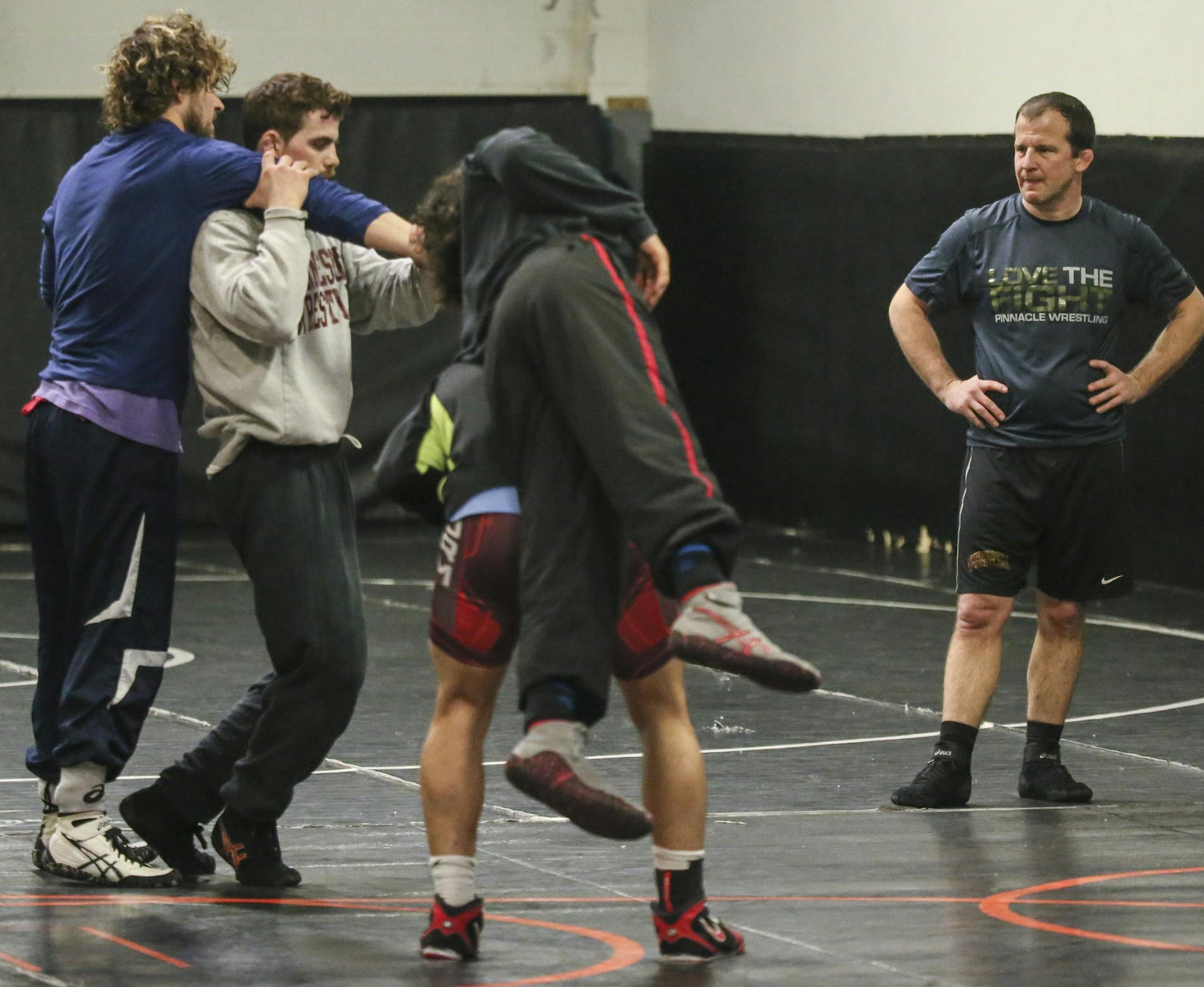 Story about how wrestling was almost kicked out of the Olympics in 2013--if it had been, this would have been the last Olympic trials ever. But they saved it, on condition that they make some changes to the rules to make the sport more exciting. Here, former Olympian and coach Brandon Paulson, works with wrestlers at his Pinnacle training facility in Shoreview.] Brian.Peterson@startribune.com Shoreview, MN - 03/31/2016