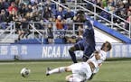 Maryland's Chase Gasper,slide-tackled Akron's Adbi Mohamed, left, during the 2018 NCAA College Cup soccer match Dec. 9. Gasper was selected by Minneso