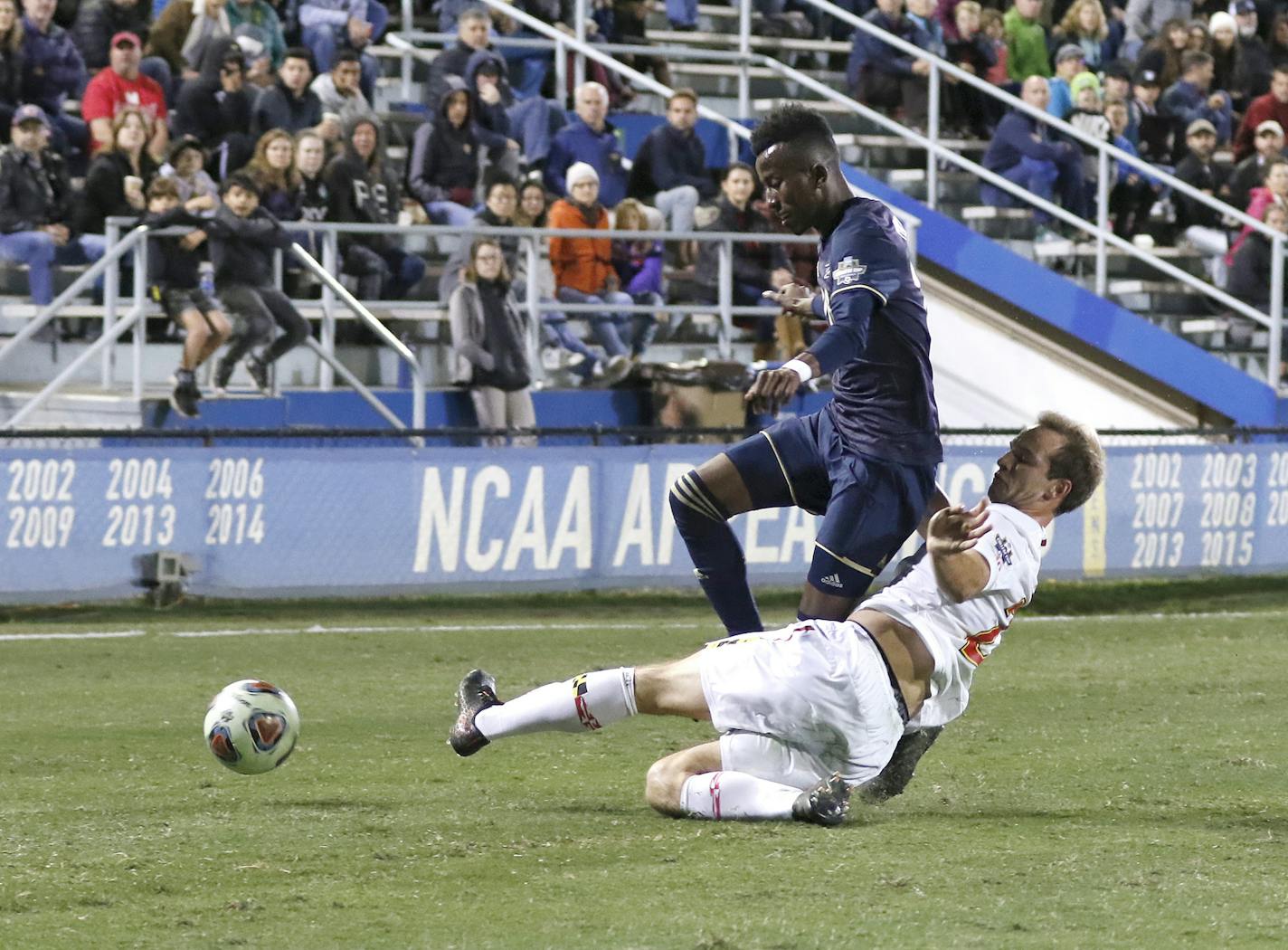 Maryland's Chase Gasper,slide-tackled Akron's Adbi Mohamed, left, during the 2018 NCAA College Cup soccer match Dec. 9. Gasper was selected by Minnesota United with a first-round pick in the Jan. 11 SuperDraft.