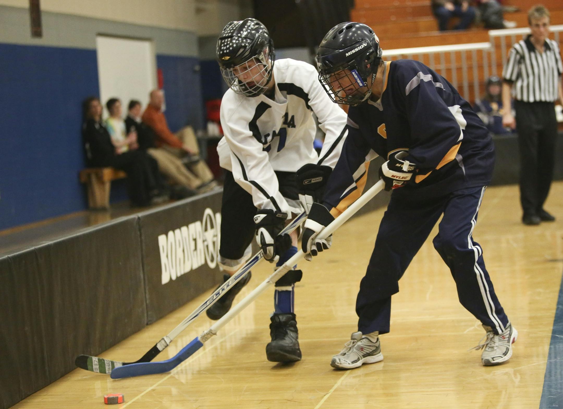 Dakota United's Grayson Nicolay and Robbinsdale's Joe Dubisar fought for the puck in the second period during the physically impaired adapted floor hockey state Championship in Bloomington, Min., Saturday, March 16, 2013. Roobinsdale/Hopkins/Mound Westonka won over Dakota United 5-0