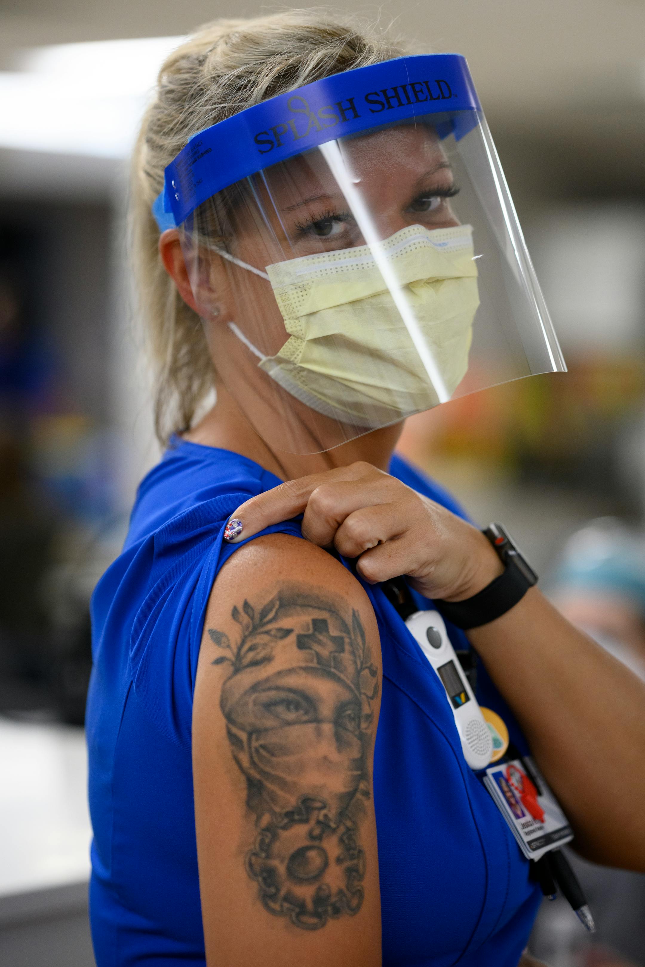 North Memorial nurse Jessica White showed off her COVID nurse tattoo while visiting the South Seven Intensive Care Unit during her lunch break Friday.