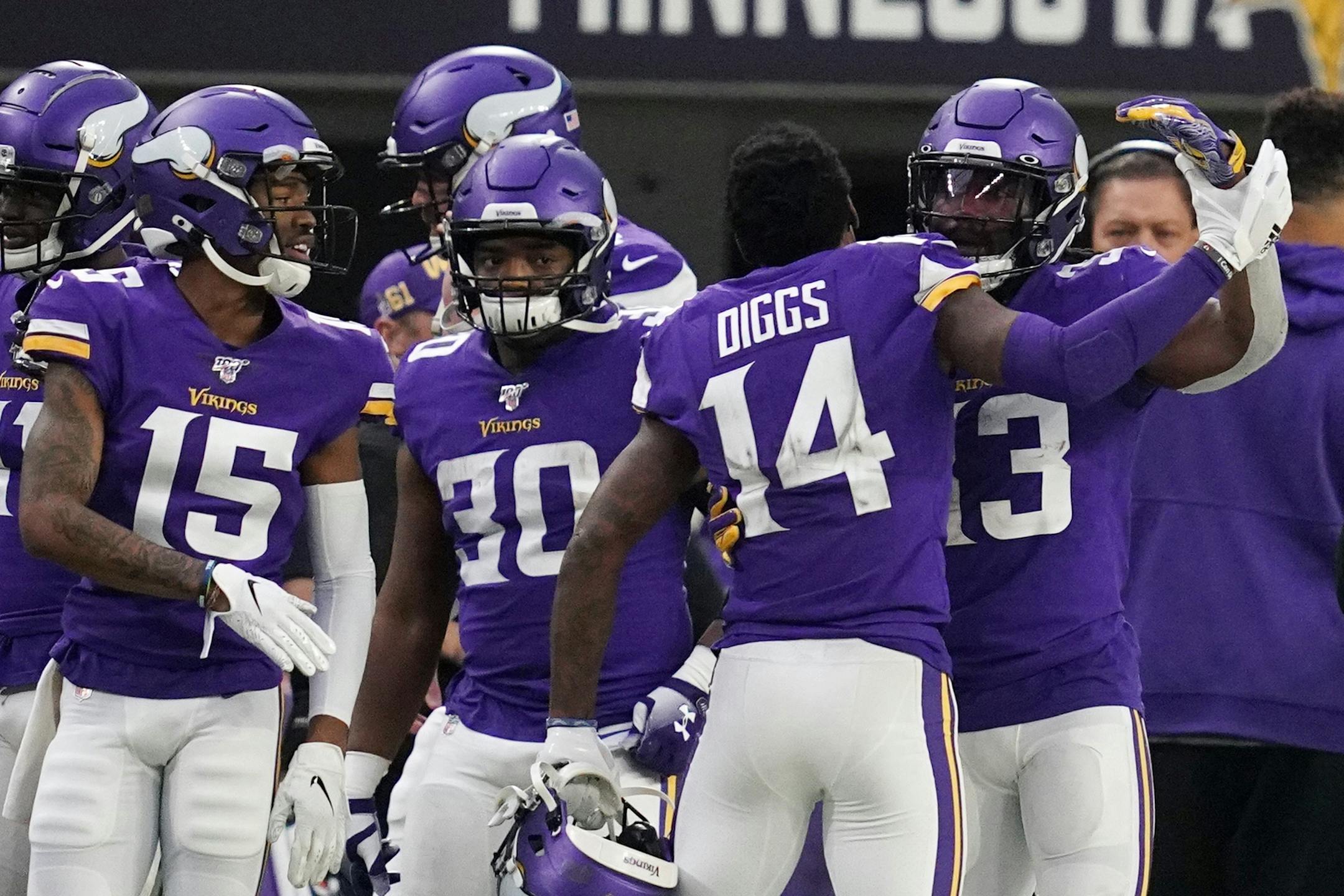 Minnesota Vikings running back Dalvin Cook (33) was congratulated by Minnesota Vikings wide receiver Stefon Diggs (14) after he scored a touchdown late in the second quarter.
