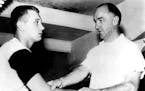 July 27, 1955 Heat Gets Gordy: Gordon Sundin, left, former Minneapolis Washburn athlete who signed a Baltimore contract Saturday, overdid things a bit