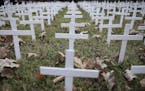 Toby Gregory's yard that is adorned with 1,006 white crosses to represent Oklahoma deaths due to COVID-19, Wednesday, Oct. 14, 2020, in Tulsa, Okla. G