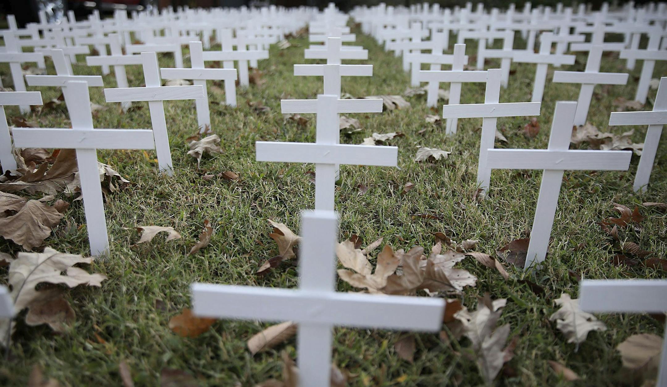 Toby Gregory's yard that is adorned with 1,006 white crosses to represent Oklahoma deaths due to COVID-19, Wednesday, Oct. 14, 2020, in Tulsa, Okla. Gregory was able to keep up with the state death toll until last week, and then it became too many. He says he doesn't have the room or supplies to keep up with the current death toll, but will do about 50 more crosses. (Mike Simons/Tulsa World via AP)