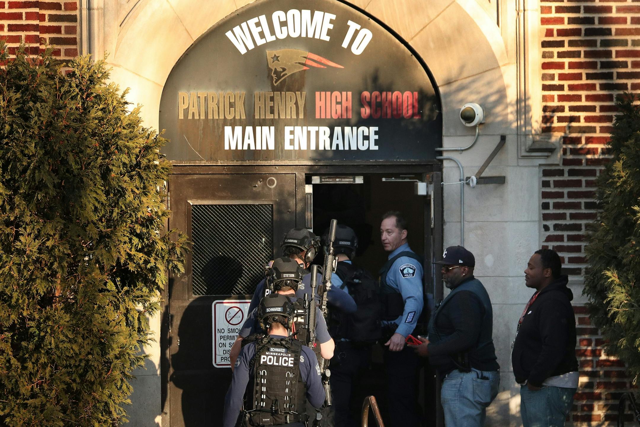 Police in tactical gear entered Patrick Henry High School after a gunman was reported getting off a Metro Transit bus near the school Tuesday.