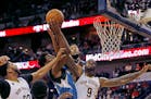 Minnesota Timberwolves forward Andrew Wiggins, second from left, and center Karl-Anthony Towns, third from left, scramble for a rebound against New Or