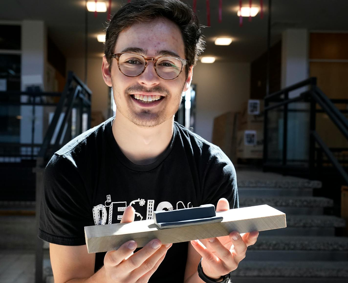 University of Minnesota College of Design student Liam Arbeiter, a sophomore from Maple Grove, with his redesign window lock he created from clay for an Anderson Windows project and seen at Ralph Rapson Hall at the U of M Tuesday in Minneapolis. ]