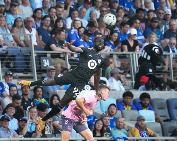 Minnesota United's Kemar Lawrence (92) heads the ball above Everton's Nathan Patterson in the first half.