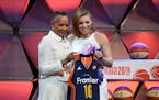 Minnesota's Rachel Banham, right, stands with WNBA President Lisa Borders after the Connecticut Sun chose Banham with the fourth pick in the WNBA draf