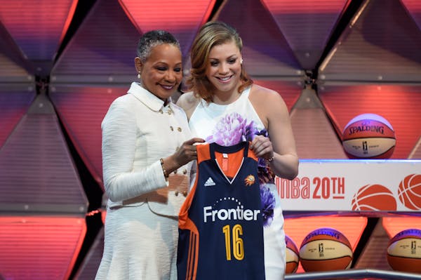 Minnesota's Rachel Banham, right, stands with WNBA President Lisa Borders after the Connecticut Sun chose Banham with the fourth pick in the WNBA draf