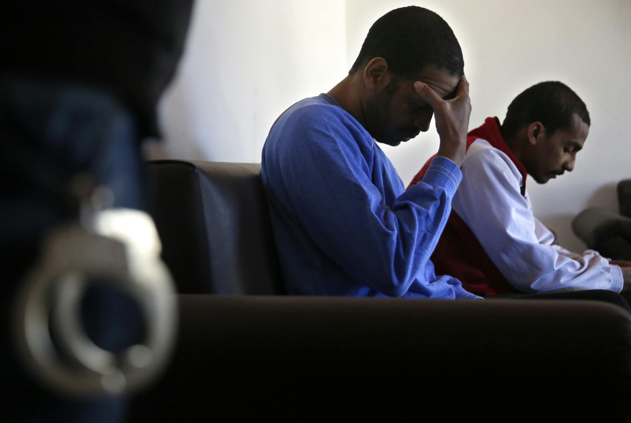 Alexanda Amon Kotey, left, and El Shafee Elsheikh, who were allegedly among four British jihadis who made up a brutal Islamic State cell dubbed "The Beatles," sit on a sofa during an interview with The Associated Press at a security center in Kobani, Syria, Friday, March 30, 2018. (AP Photo/Hussein Malla)