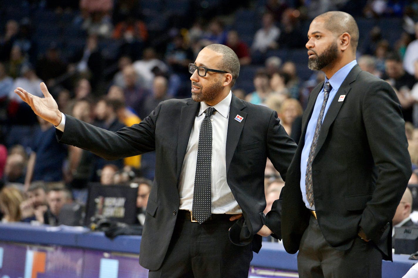 David Fizdale, left, talks with associate head coach J. B. Bickerstaff