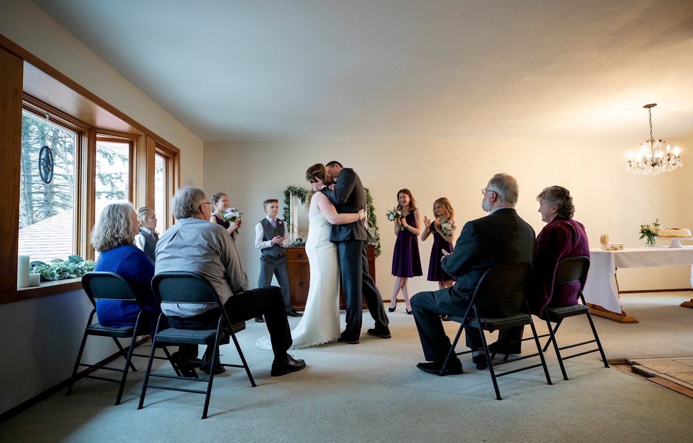 Bride Jamie and groom Ross Buchanan kissed during a wedding ceremony in their living room. A computer was used to livestream the wedding for friends and family. ] CARLOS GONZALEZ • cgonzalez@startribune.com – Roseville, MN – March 18, 2020, Living room Wedding of Ross and Jamie Buchanan -- Coronavirus (COVID-19)