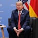 President Donald Trump listens to questions from members of the media during his meeting with Germany's Chancellor Angela Merkel at the G20 Summit, Sa