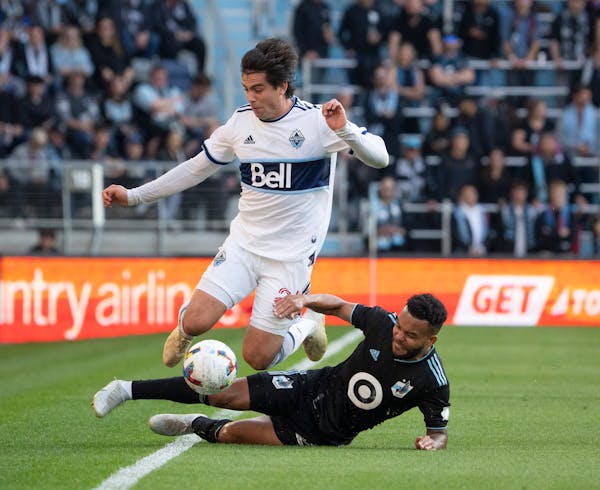 Minnesota United defender DJ Taylor, bottom, knocked Vancouver forward Brian White and the ball out of bounds in their game Sunday at Allianz Field.