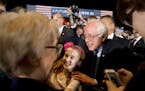 Sen. Bernie Sanders, I-Vt., takes a photograph with a girl after a campaign rally Saturday night at the Mayo Civic Center in Rochester.