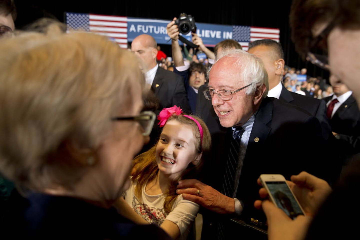 Sen. Bernie Sanders, I-Vt., takes a photograph with a girl after a campaign rally Saturday night at the Mayo Civic Center in Rochester.