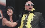 FILE -- Chyna places a feather boa on then-Gov. Jesse Ventura, during a press conference July 14, 1999 at the Target Center in Minneapolis to announce